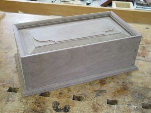 Dovetailed box with mitered, molded top edge.
