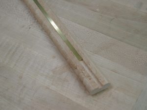 The 1/8" X 1/4" brass rub strip fits perfectly in the end mill groove.