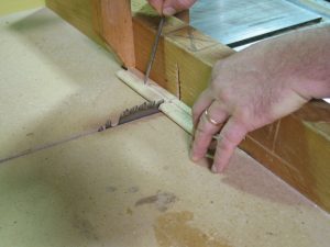 Use an awl to hold short piece when cutting to length.