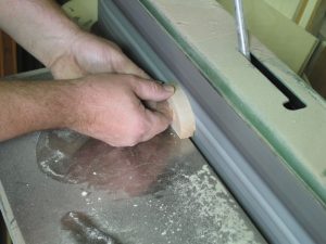 I use an edge sander to clean up all the surfaces, but you could do it by hand.