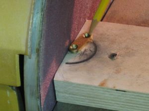 Grind the end clamps on the disc sander.