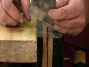 The burr on a cabinet scraper is easily seen along the edge of the steel.