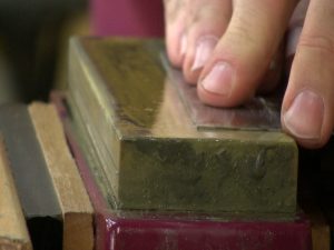 Remove any remnants of an old burr on your card scraper by honing.