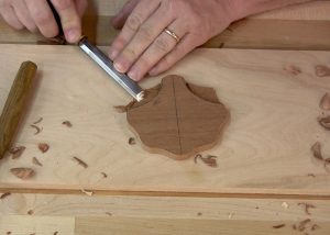 Draw the scallops, or fins, of the shell then carve them using a vee parting tool and bench chisels.