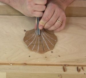 The carved details of the shell begin with separating the lobes with a v-parting tool.