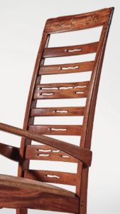 The back of the Greene & Greene Rocker is pierced and carved.