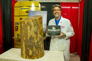 Scott "Shuttleman" Phillips with his Moon Tree log and the plaque from the Kennedy Space Center.