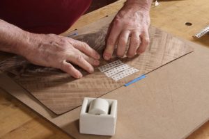 Using veneer tape, the book-matched panel is assembled.